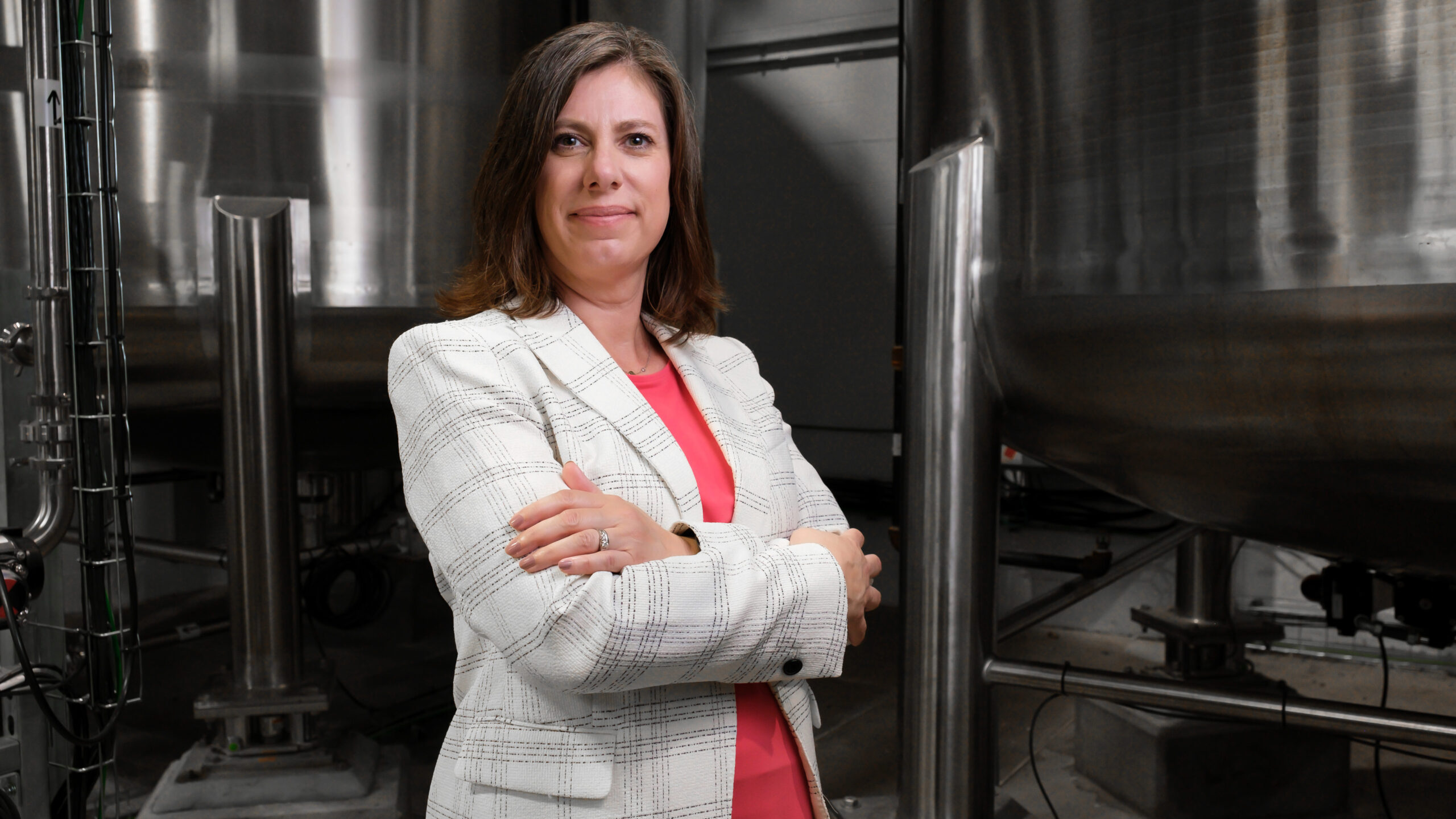 Contract manufacturing for precision inkjet inks 1 Melissa Toledo portrait with ink tanks edited scaled