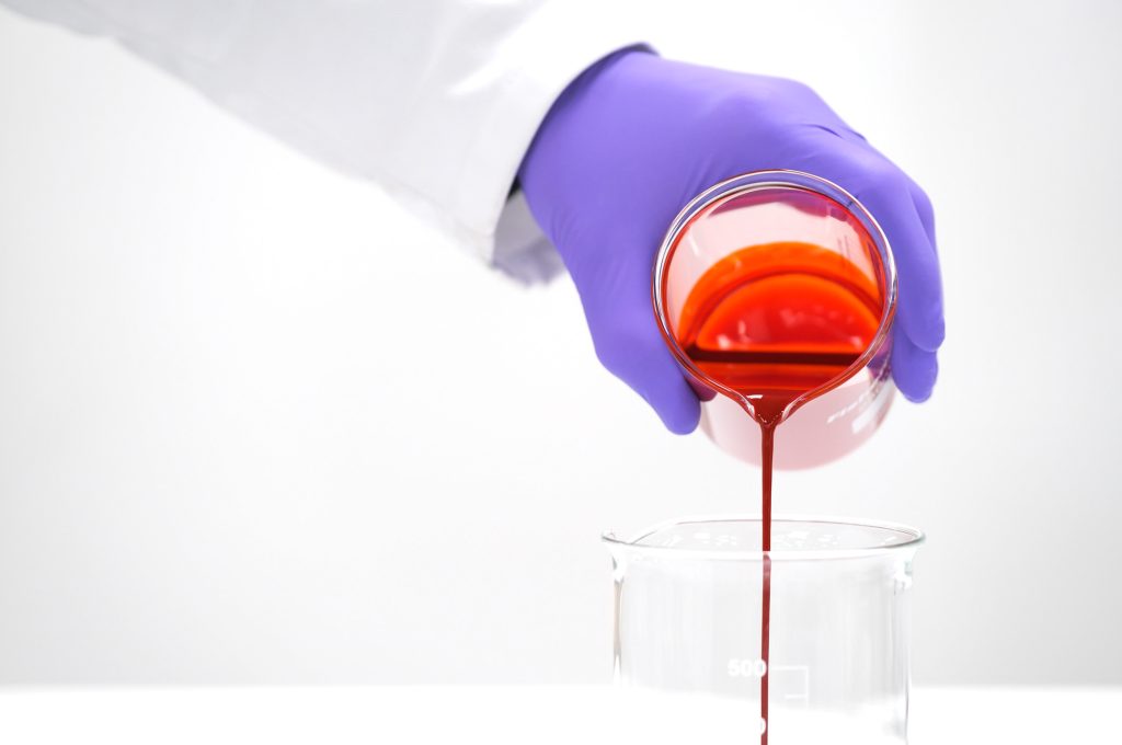 Formulate inkjet inks for extended color gamut 1 Pouring orange dispersion in laboratory 2000px